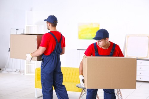 Movers loading furniture in a Harlesden street with local homes nearby