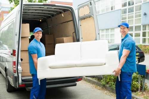Professional movers carrying boxes in a Harlesden residential move