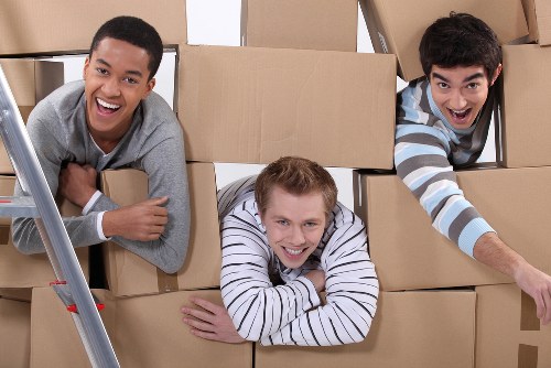 Movers carrying furniture through a residential staircase
