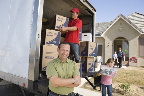 Professional moving van loading furniture and boxes in Harlesden