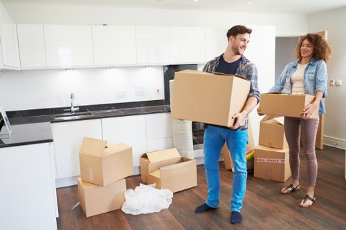 Packed office boxes and business equipment ready for a Harlesden move