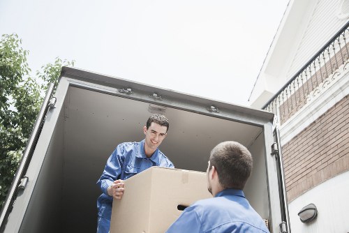 Moving boxes and furniture being loaded for a Harlesden home move