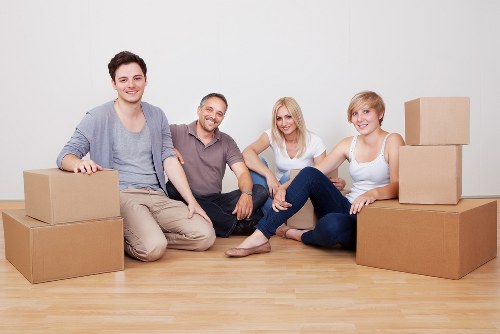Professional removal team handling furniture in a Harlesden property